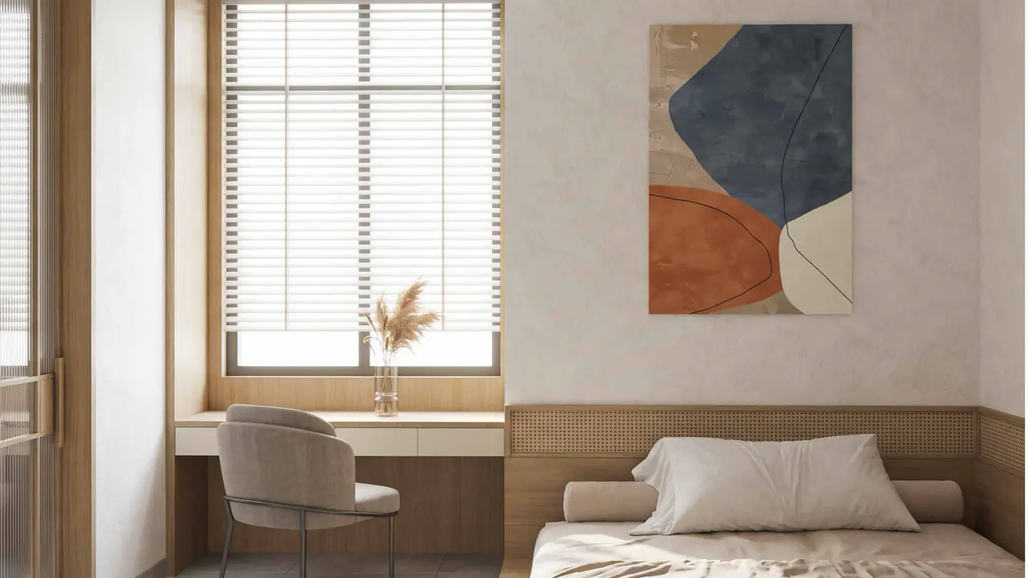 A bedroom corner with a built-in timber desk beside a shuttered window.