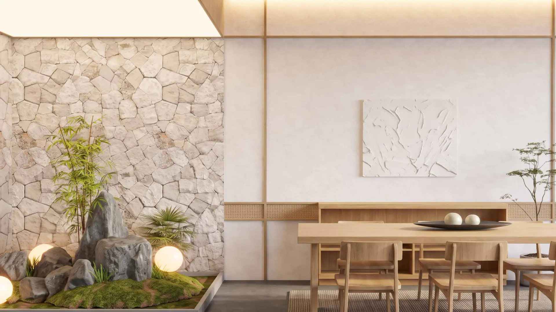 A dining table beside an indoor zen garden of moss, boulders and bamboo.