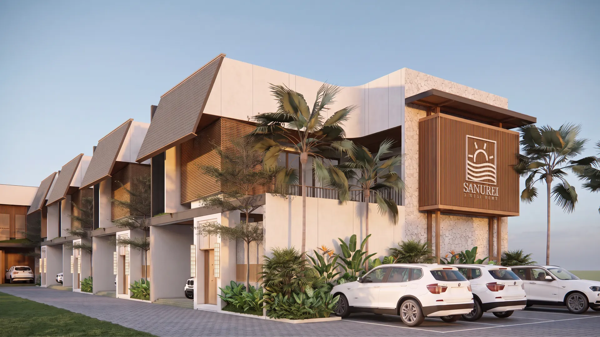 The compound entrance, signage wall and the row of villas beyond