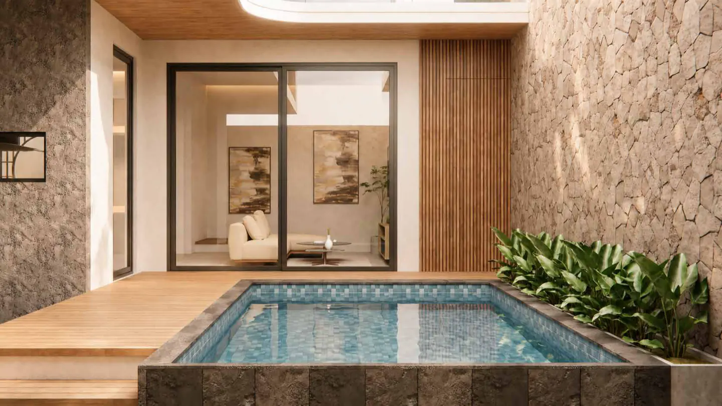 A private pool courtyard opening onto the living room through full-height glass.